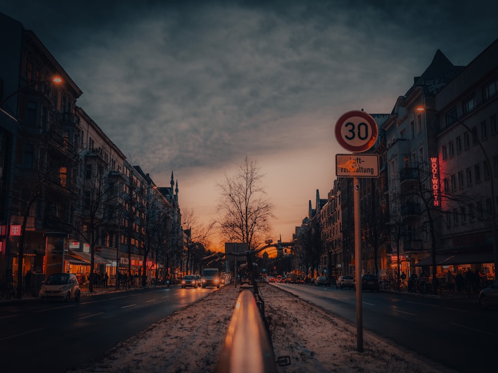 a street with a speed limit sign in the middle of it