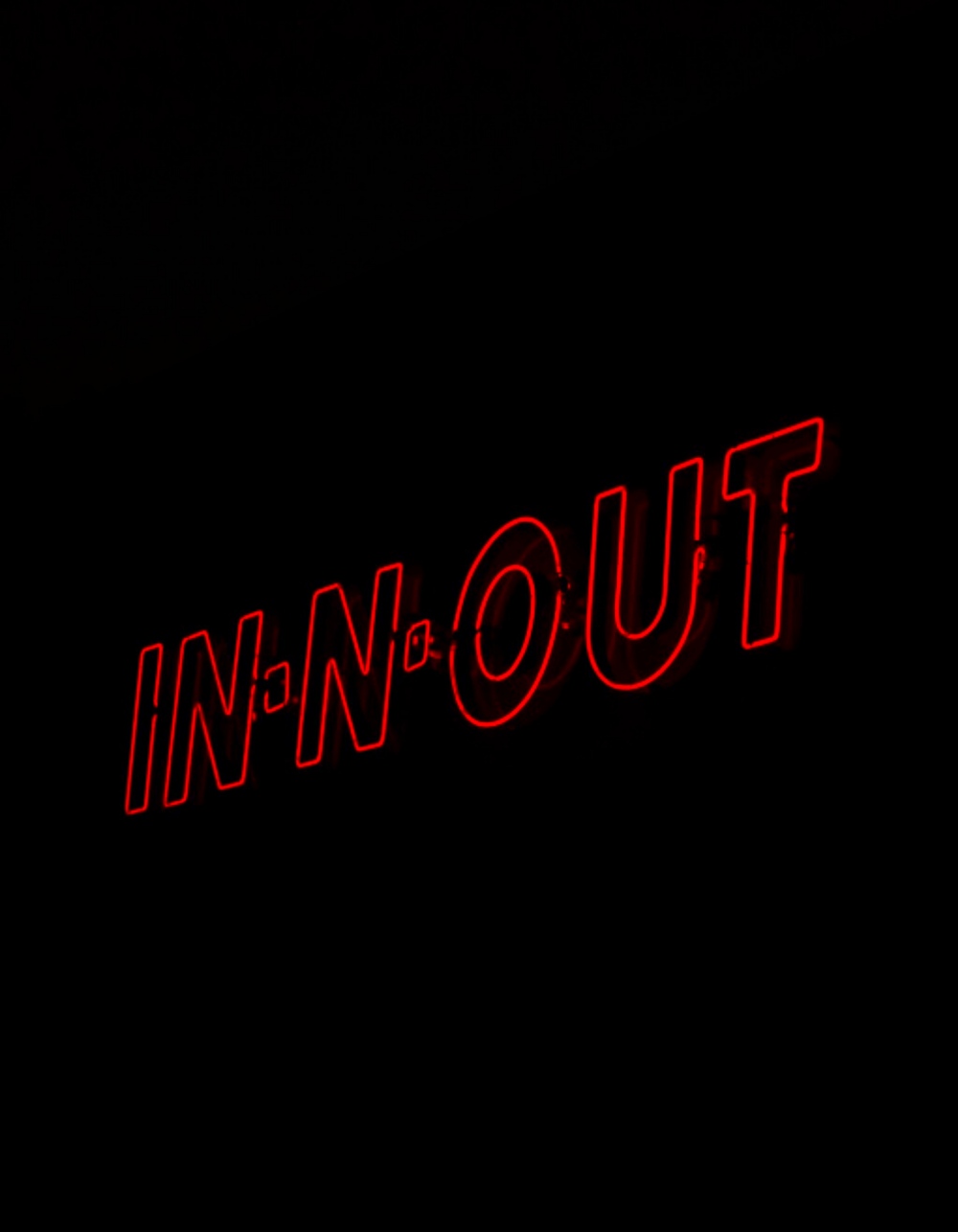 a close up of a neon sign in the dark