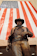 a statue of a man in a cowboy hat with an american flag in the background