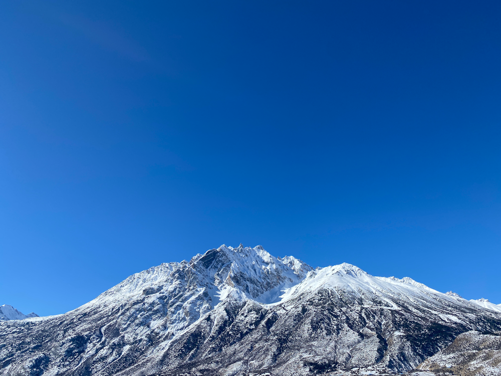 a snow covered mountain under a blue sky