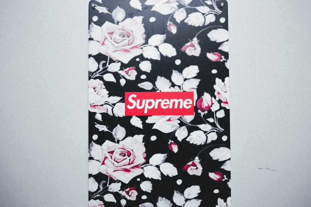 A black and white floral case with a supreme sticker on it photo – Free Rug  Image on Unsplash
