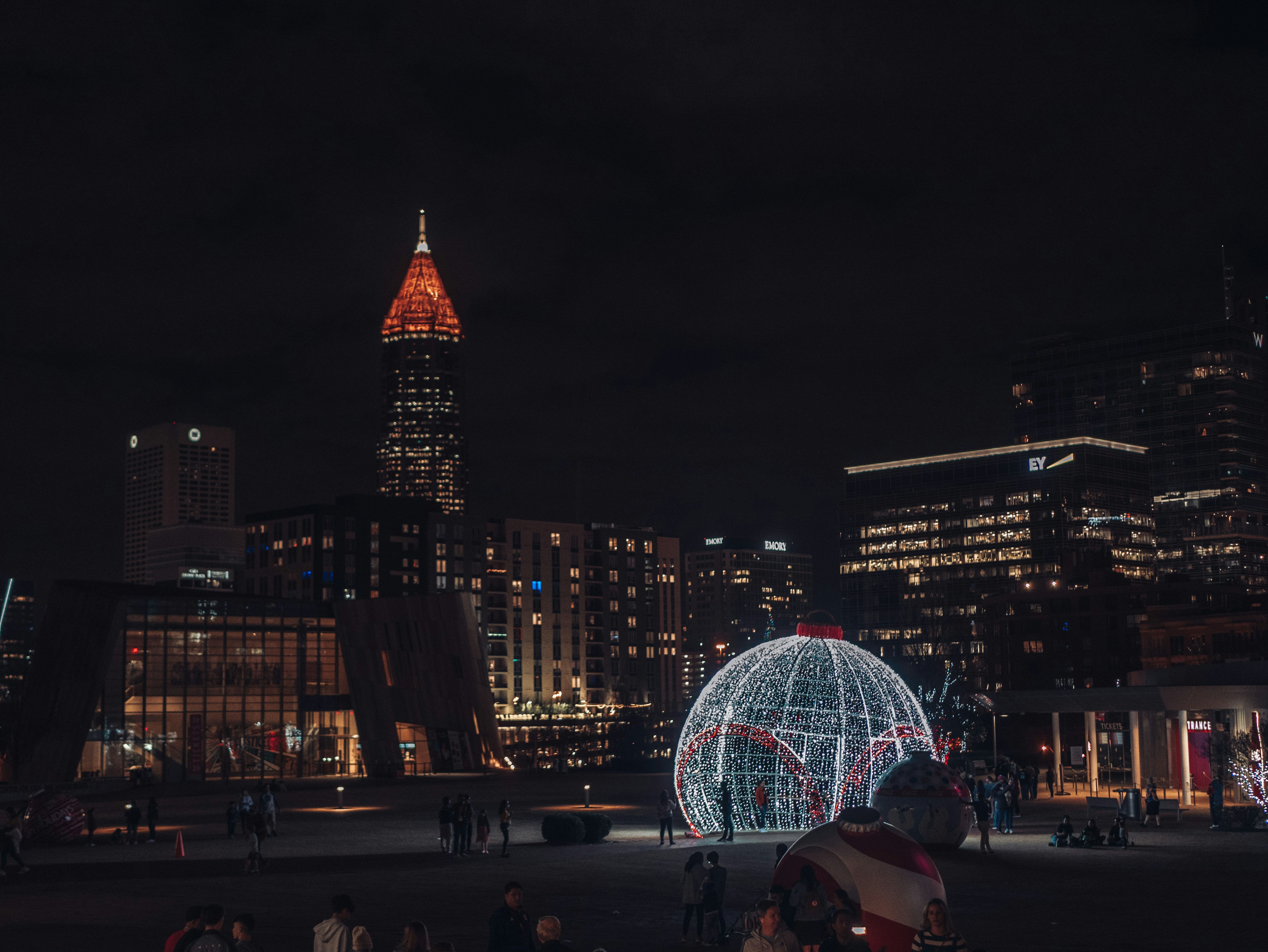 a large lighted ball in the middle of a city at night