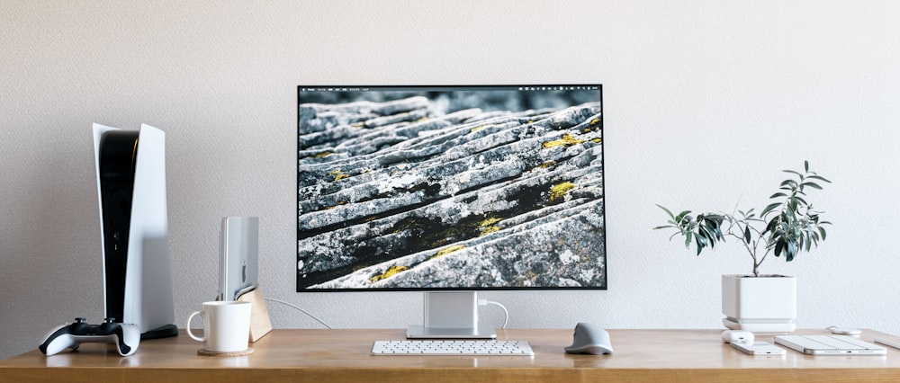 a computer monitor sitting on top of a wooden desk