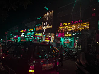 A vibrant storefront of Domino's Pizza in a busy Noida commercial area.