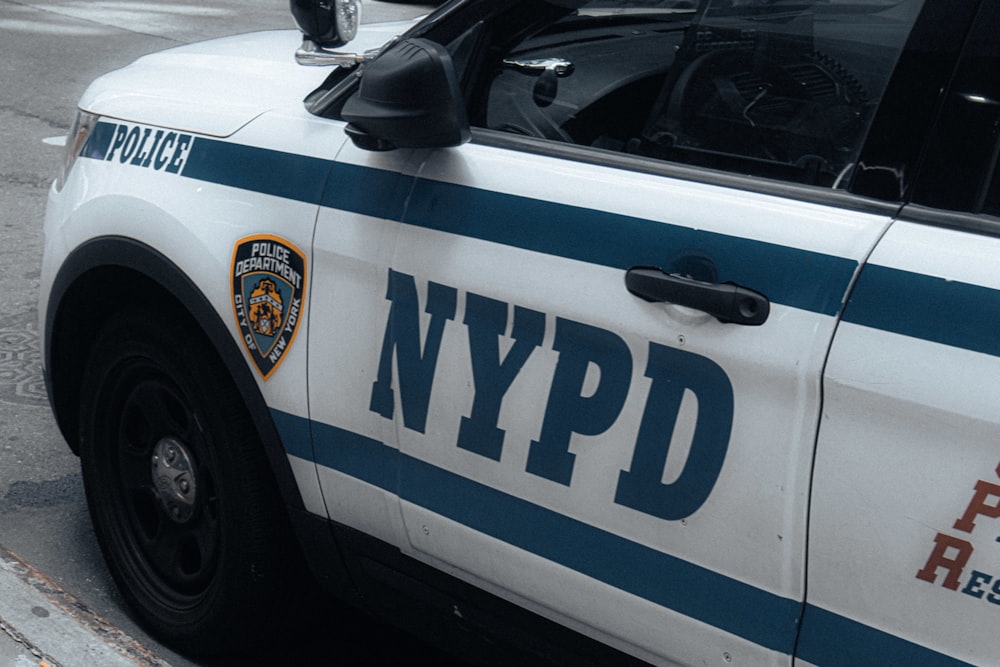 a nypd police car parked on the side of the road