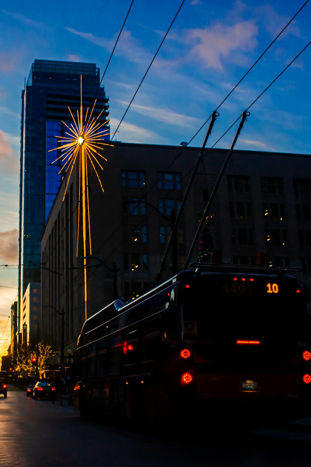 a bus driving down a street next to tall buildings