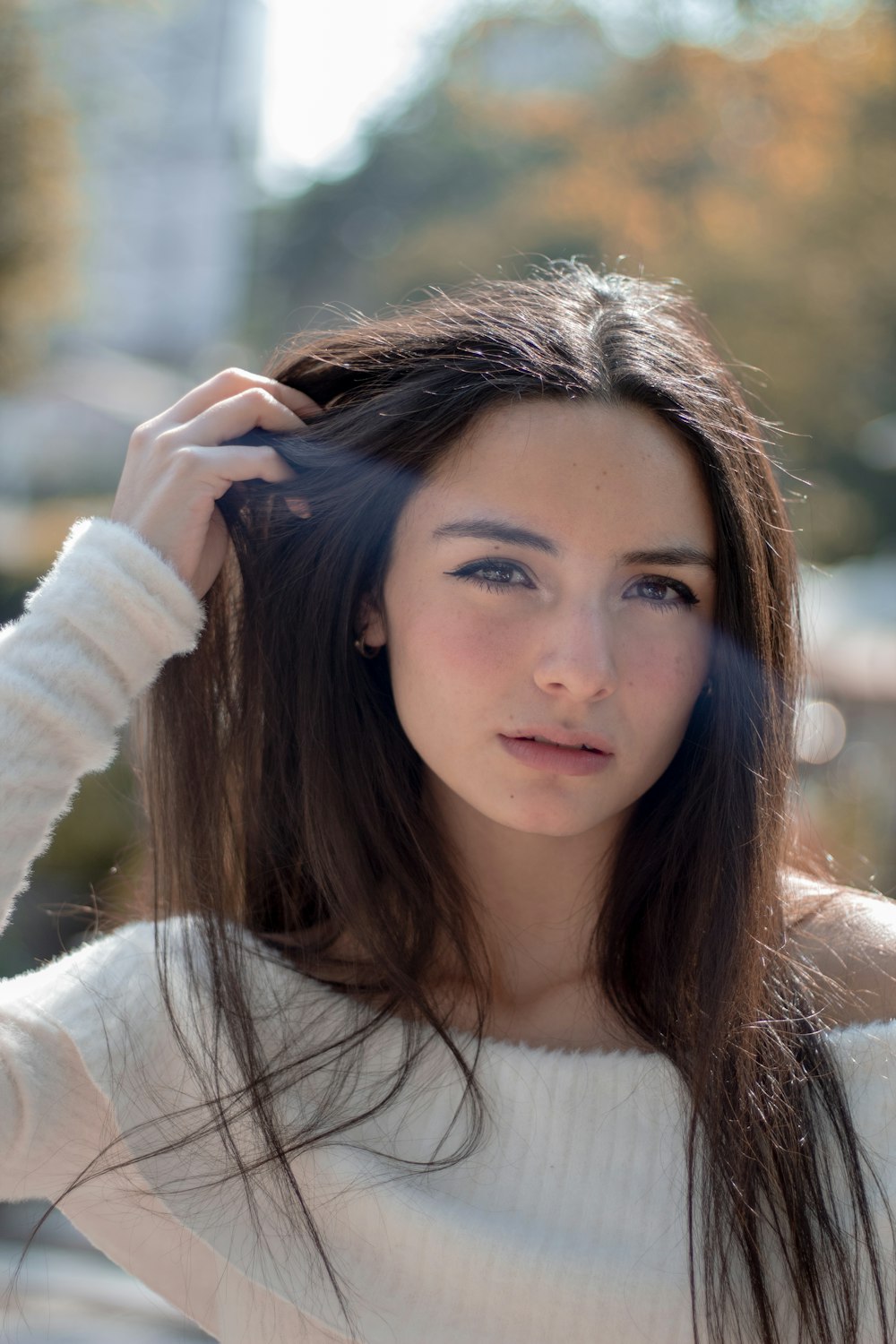 a woman with long hair is posing for a picture