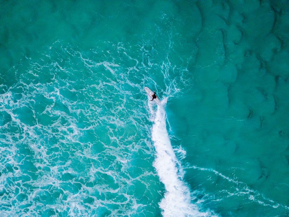 a person riding a surfboard on a wave in the ocean