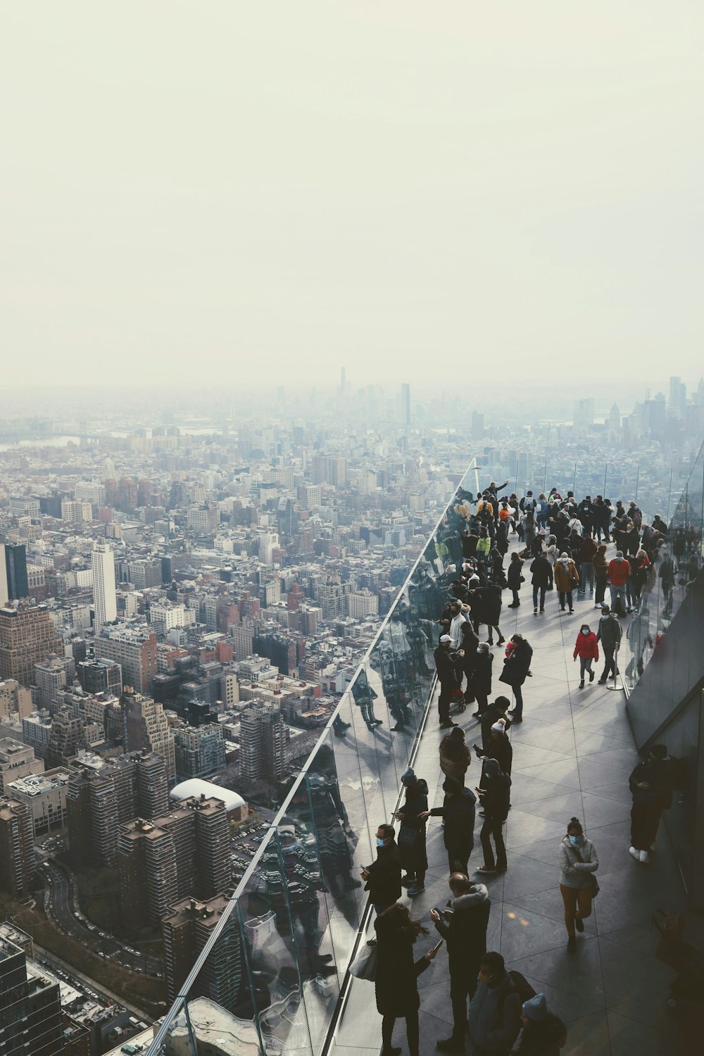 a group of people standing on top of a tall building