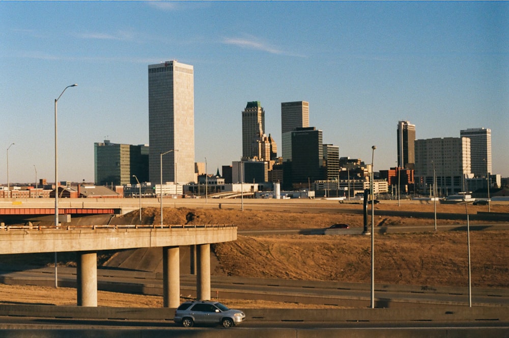 a car driving on a highway in front of a city