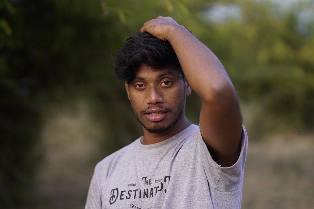 a man is holding his hair in the air