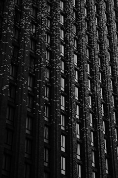 High-resolution image of a luxury residential building facade with navy, black, and gold accents under soft studio lighting.