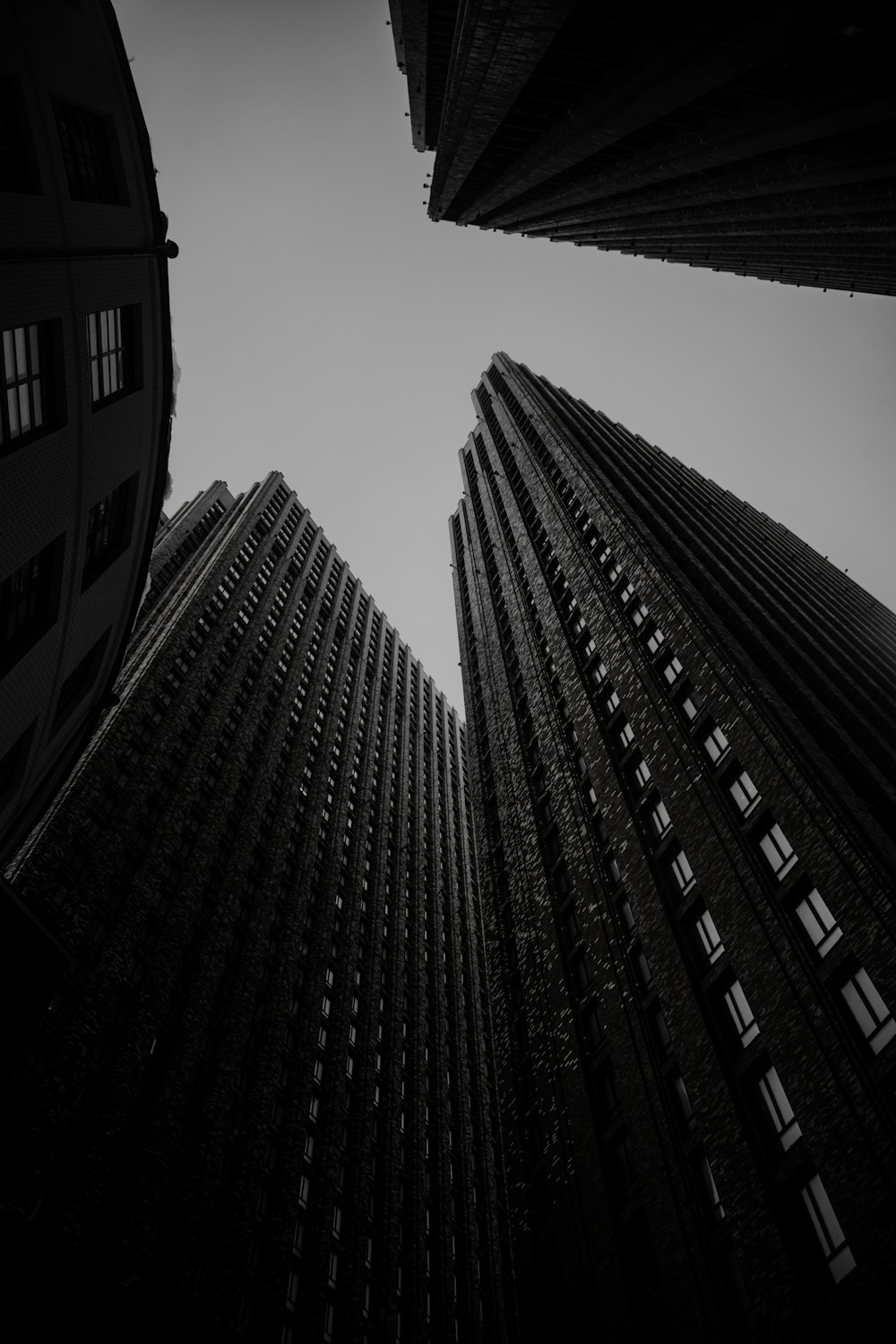 a black and white photo of two tall buildings