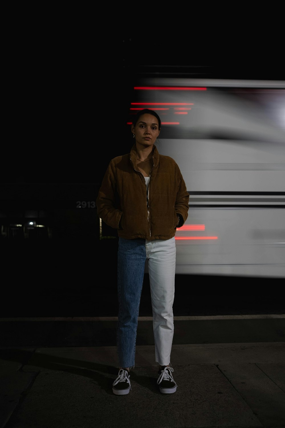 a man standing in front of a train at night