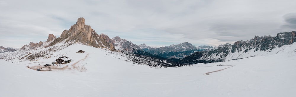 a man riding a snowboard down the side of a snow covered slope