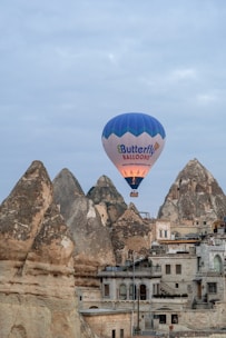 a hot air balloon flying over a city