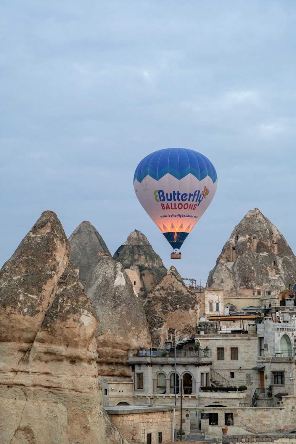 a hot air balloon flying over a city