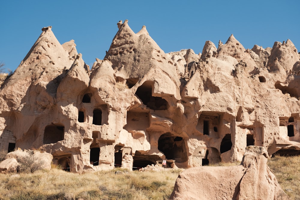 a group of buildings made of rocks in the desert