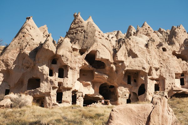 A group of buildings made of rocks in the desert — Cappadocia, Turkey