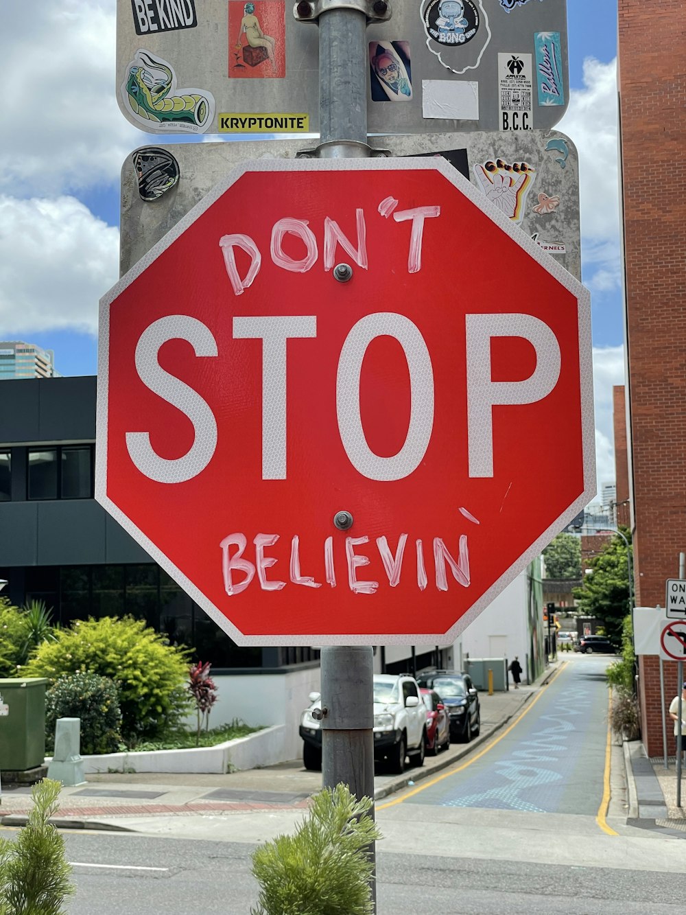 a stop sign has been vandalized with stickers