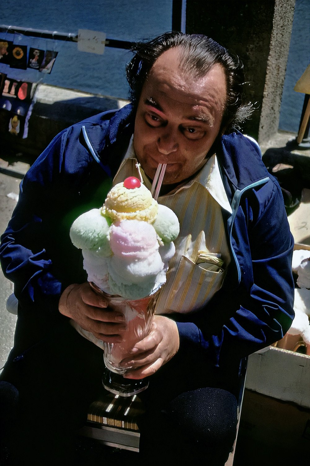 a man holding a tall glass filled with ice cream
