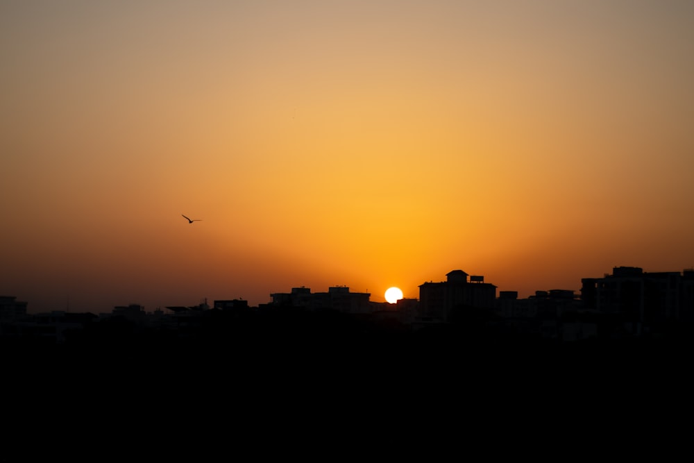 the sun is setting over a city skyline