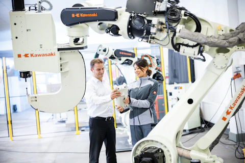 Engineers with industrial robot
