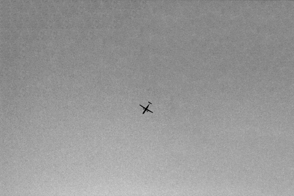 an airplane is flying high in the sky