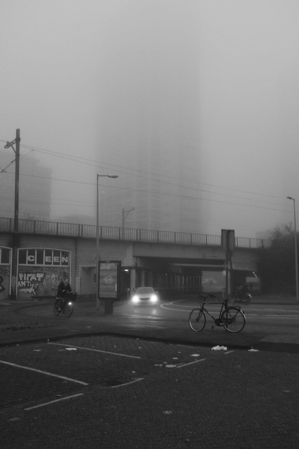 a black and white photo of a foggy street