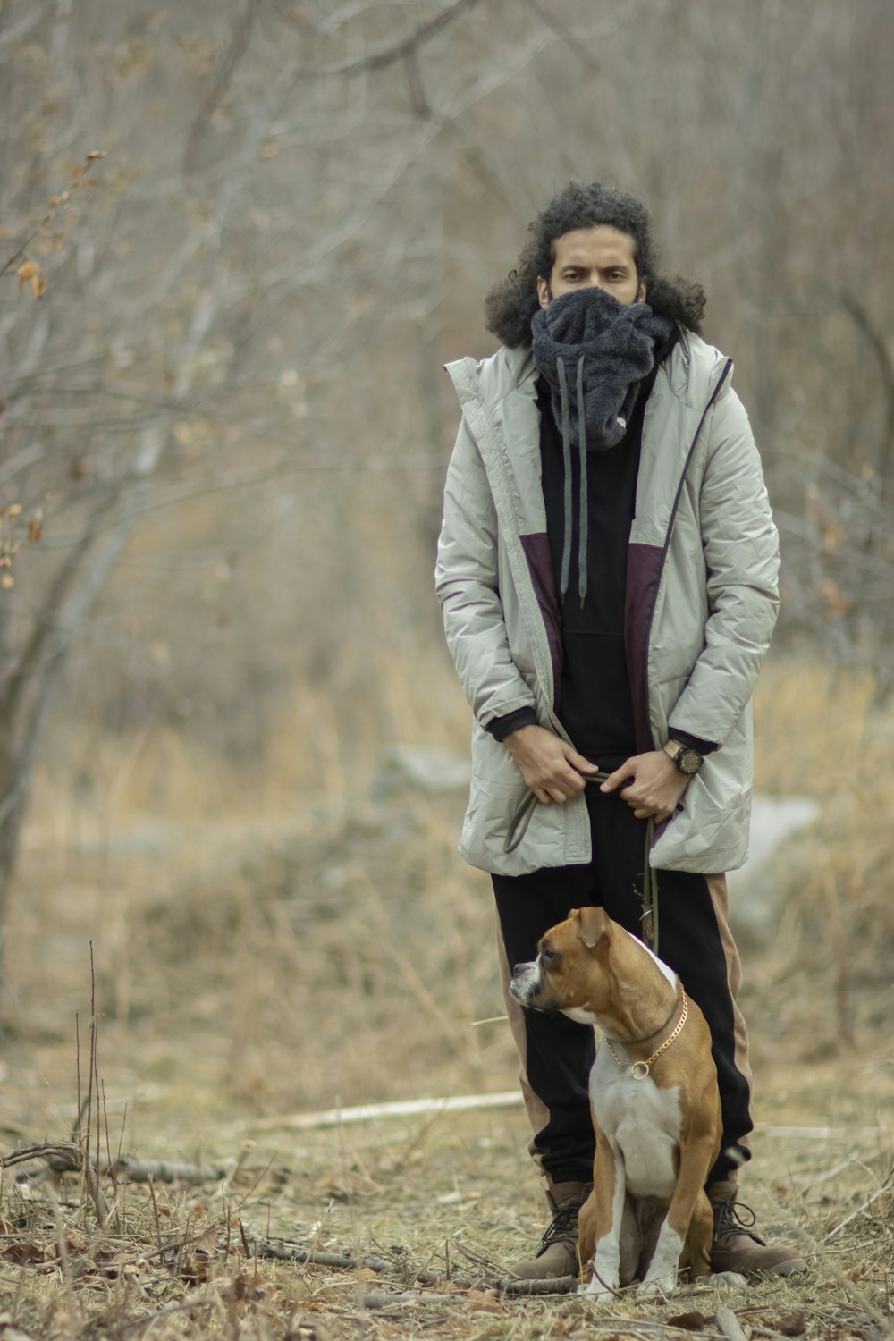 a man and his dog are standing in the woods