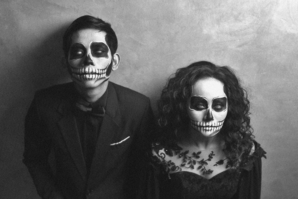 a man and a woman in skeleton makeup