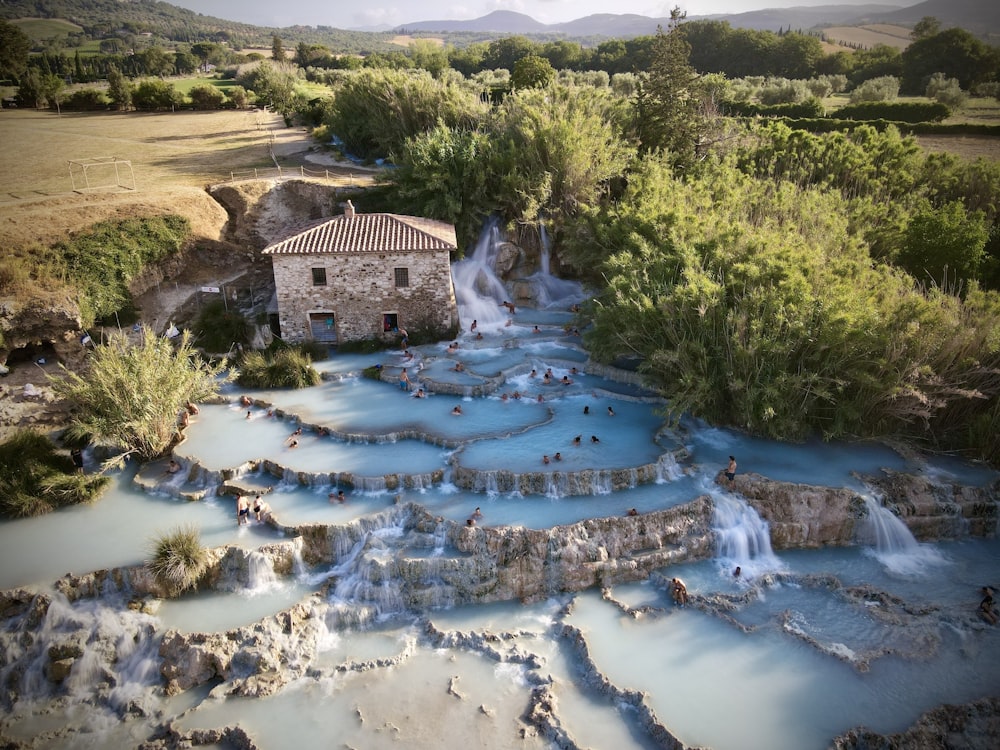 an aerial view of a hot springs with a house in the background