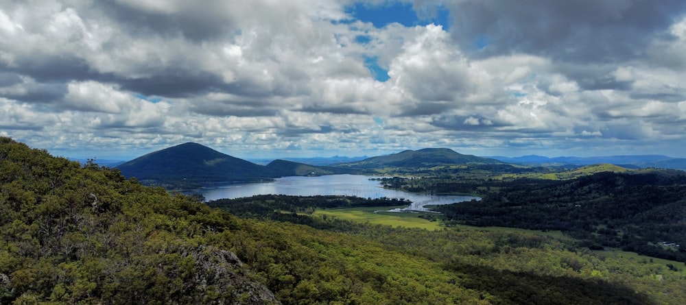 a scenic view of a lake surrounded by mountains