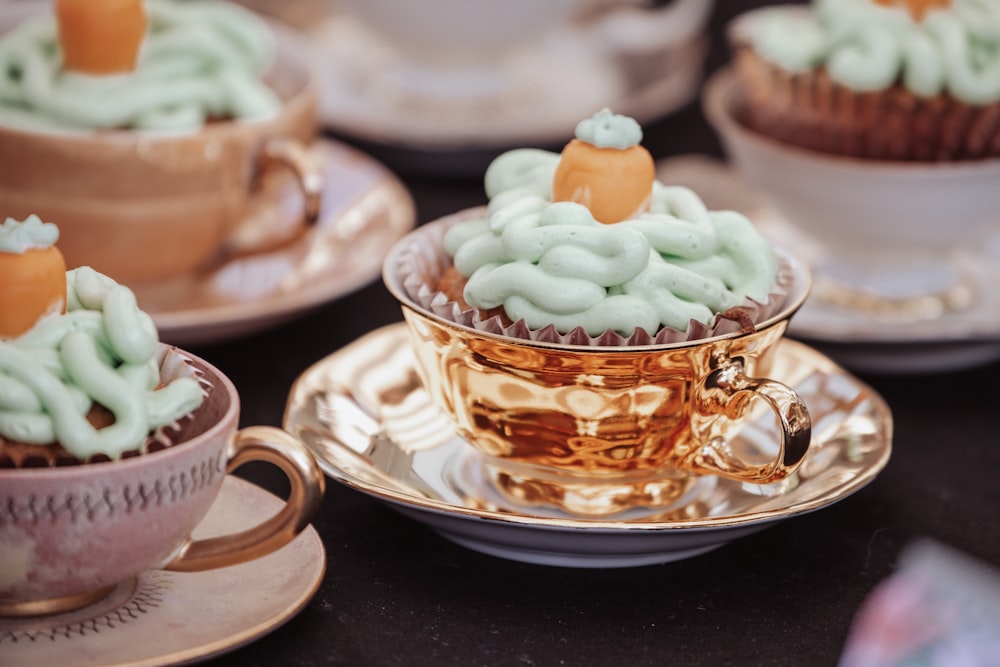 cupcakes with green frosting in a cup on a saucer