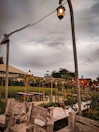 Outdoor seating area with lanterns and jungle sounds in the background.