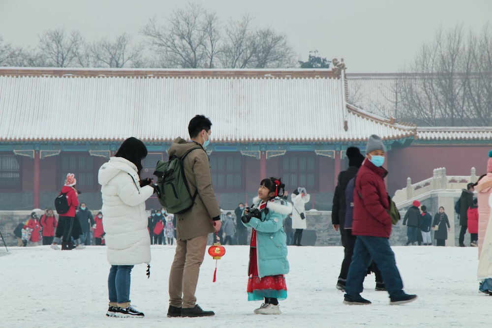 a group of people standing in the snow
