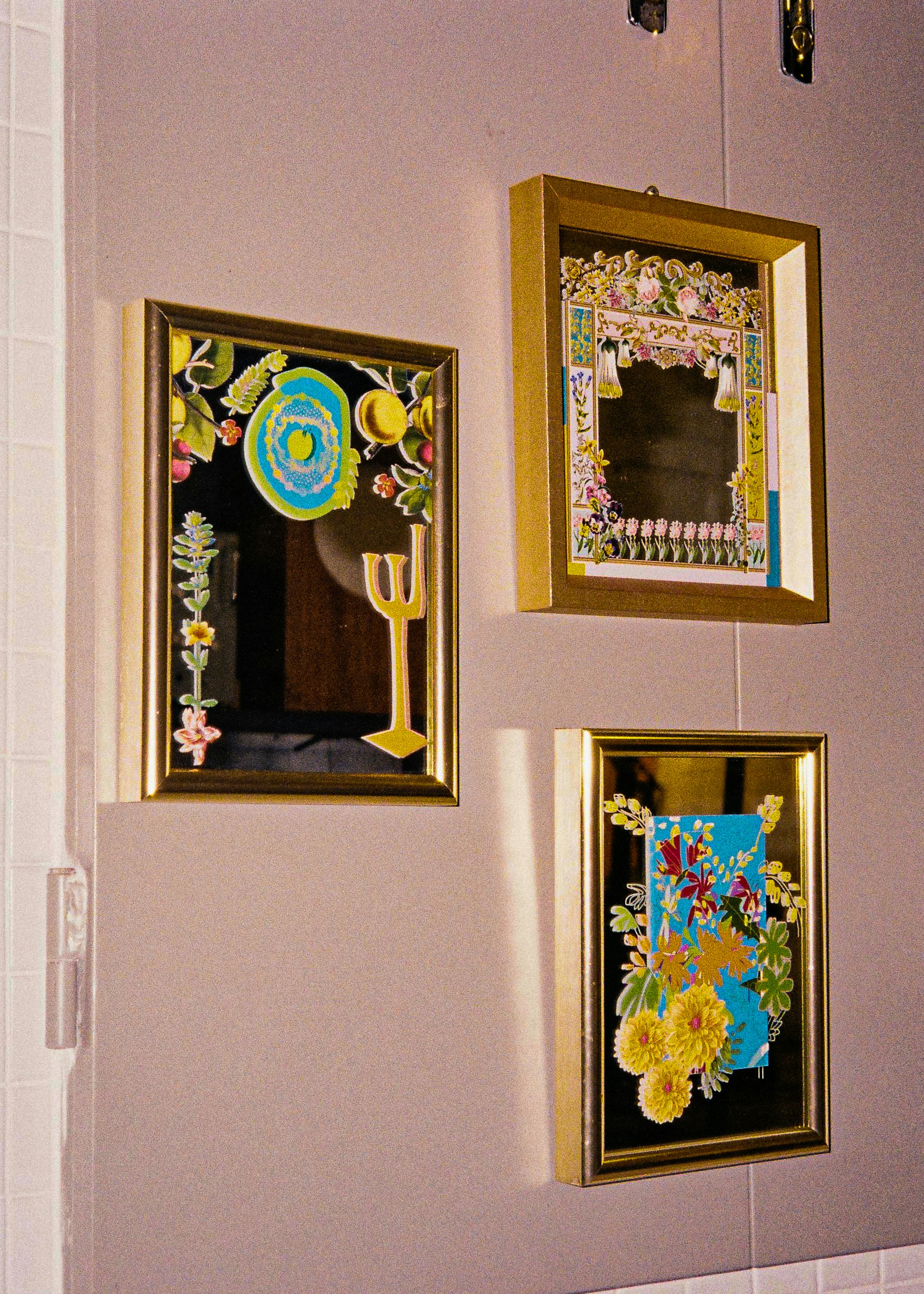 a wall with three framed pictures on it