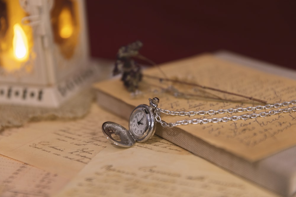 a close up of a pocket watch on a book