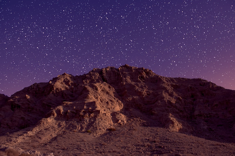 the night sky is full of stars above a mountain