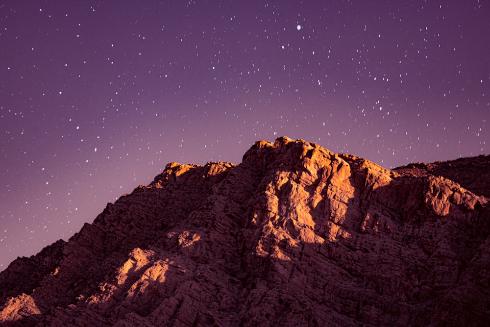 the night sky over a rocky mountain range