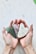 A close-up of a hand holding a heart-shaped stone, symbolizing love and connection.
