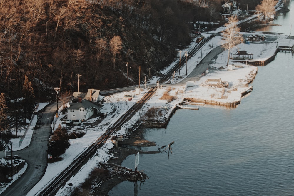 an aerial view of a train track next to a body of water