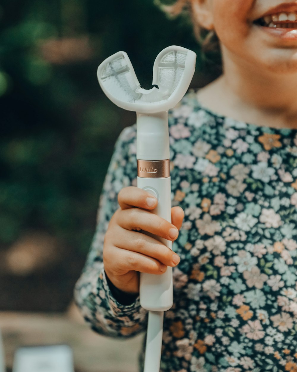 a close up of a person holding a toothbrush