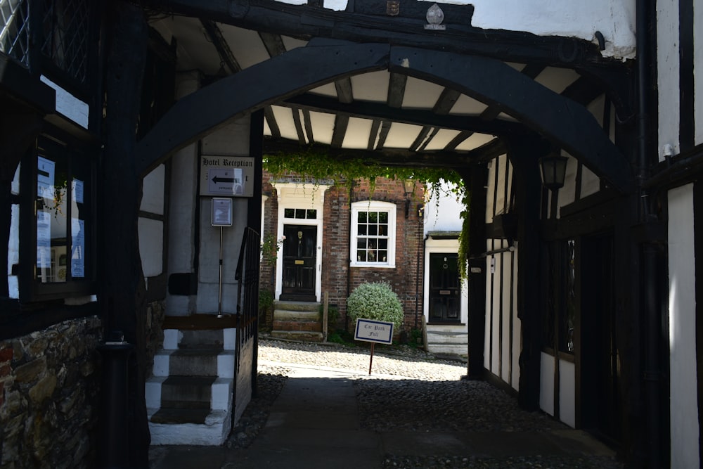 an archway leading to a building with a potted plant