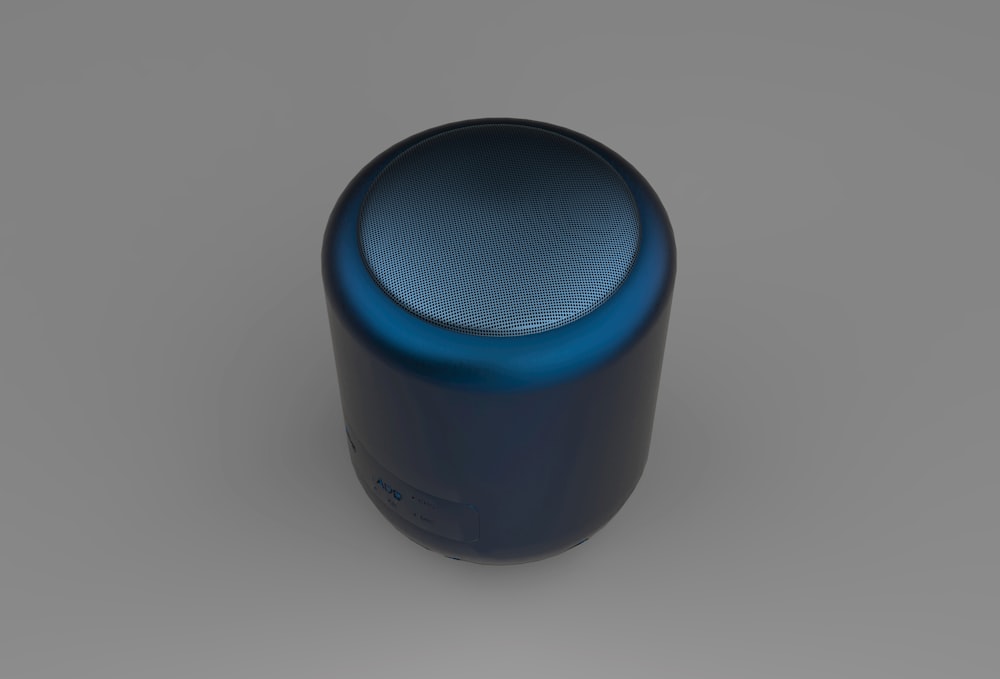 a blue speaker sitting on top of a table