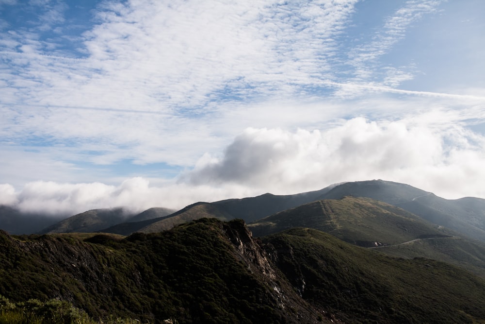 a view of a mountain range with clouds in the sky