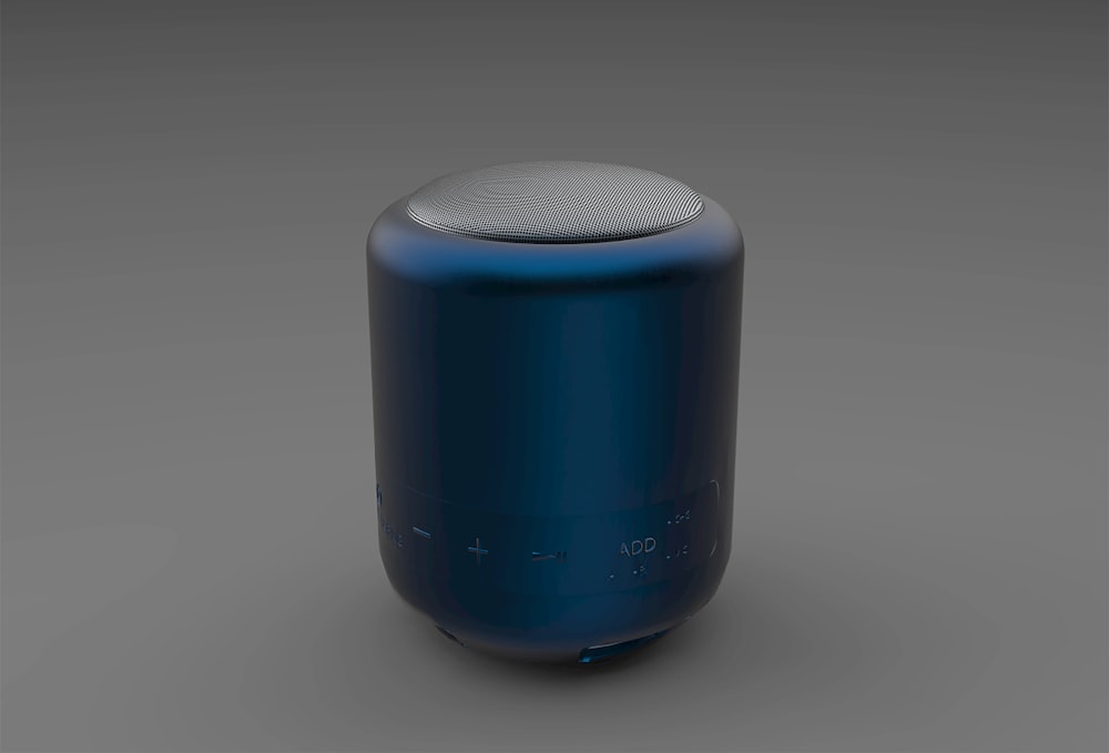 a blue and white speaker sitting on top of a table