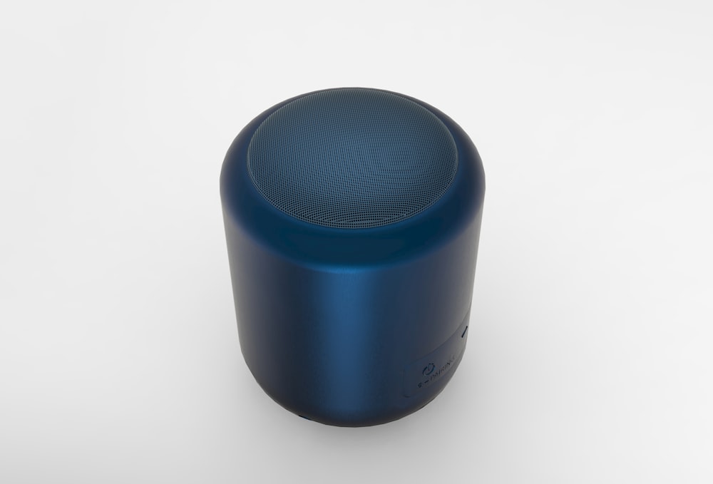a blue speaker sitting on top of a white table