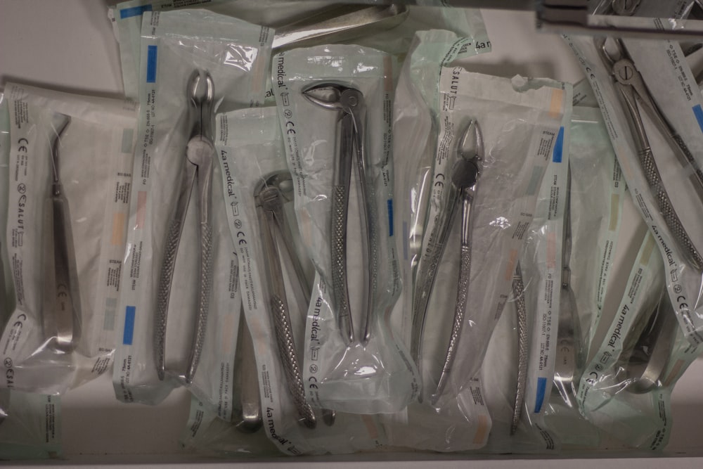 a bunch of forks and spoons in plastic bags