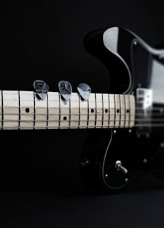 a close up of a black electric guitar